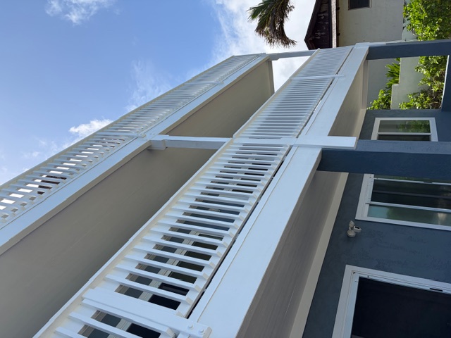 Two-story residence with finished white railings against blue siding