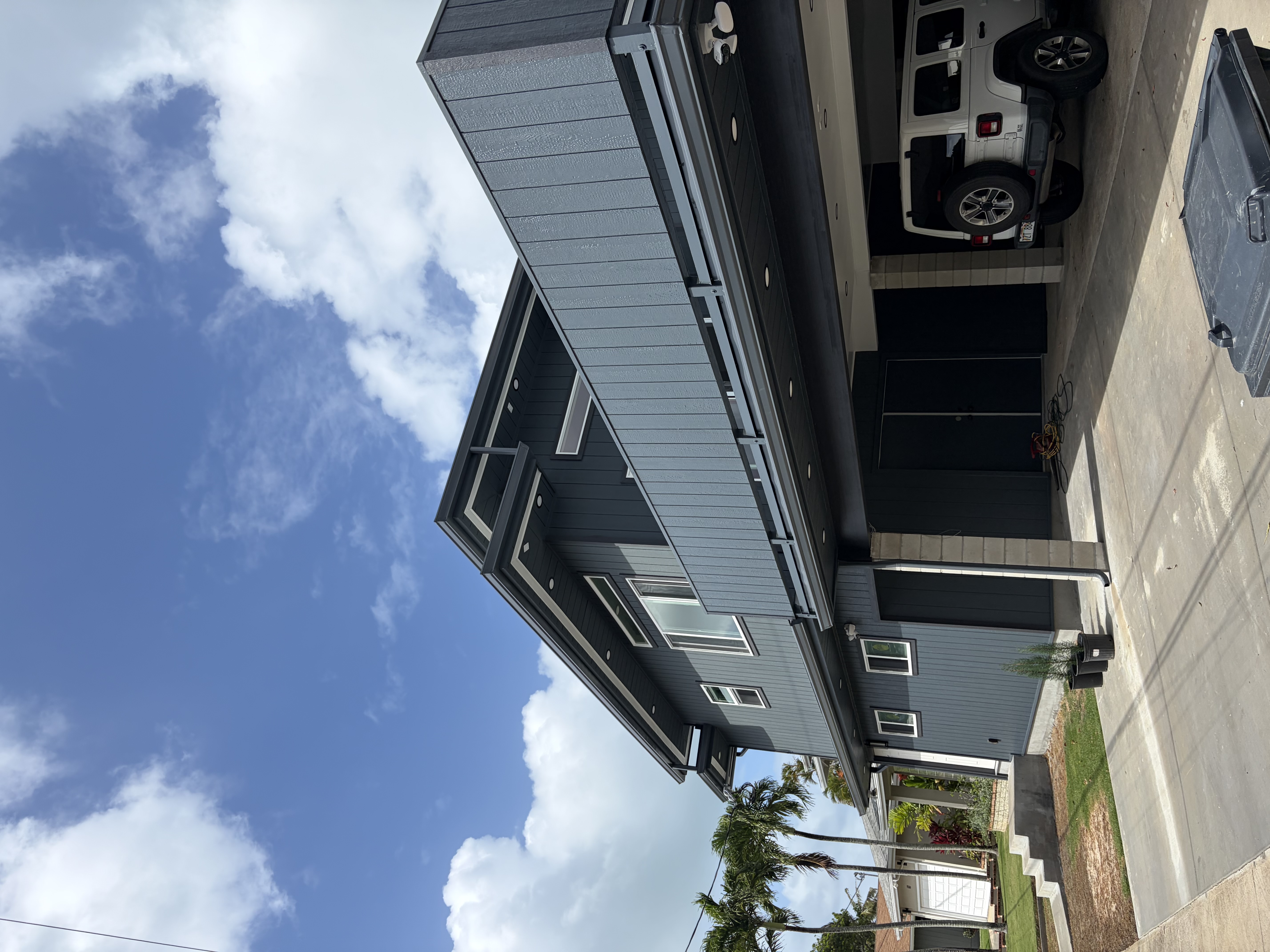 Modern residence finished in deep slate with crisp white window trim